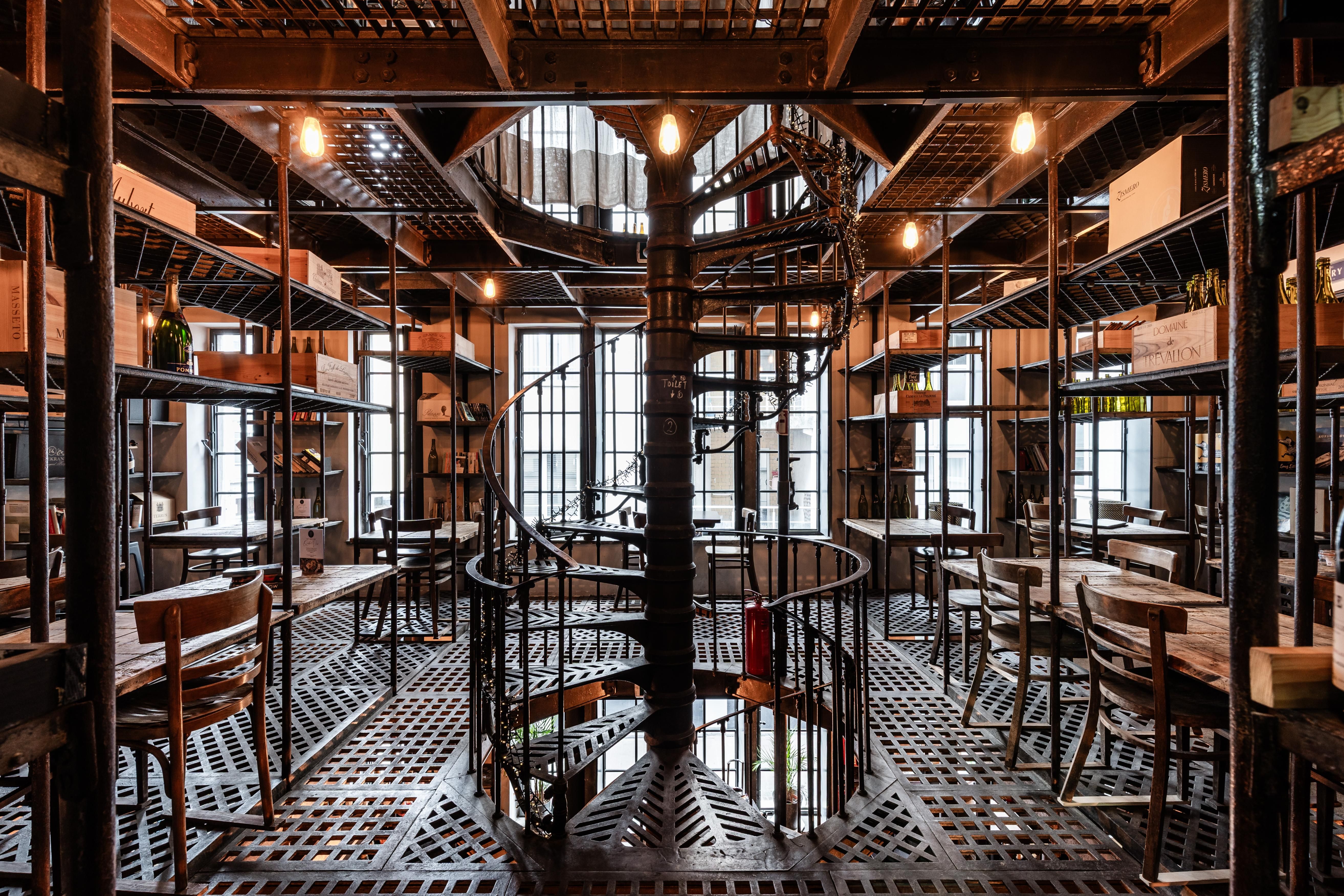 Cafe met een stalen interieur en centraal een stalen spiltrap